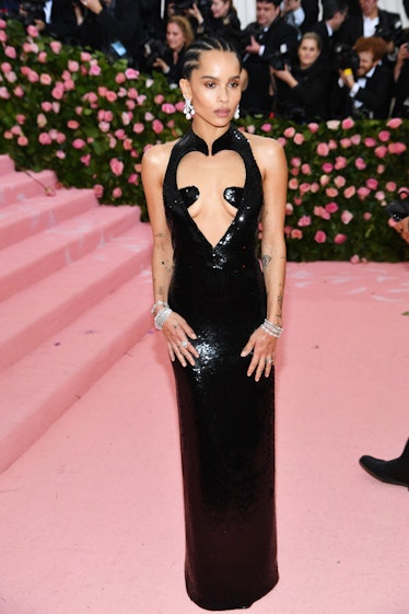 Zoe Kravitz at the Met Gala in a long black gown with a hear cut-out on the chest 