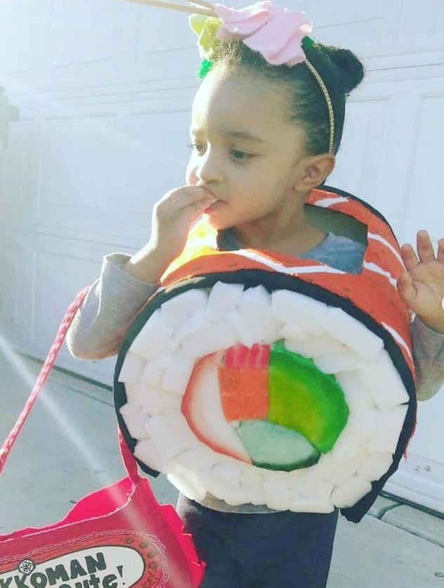 Little girl dressed up in costume to look like a sushi roll