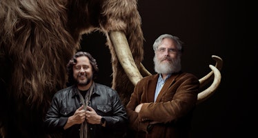 Ben Lamm and George Church of Colossal posing in front of a mammoth