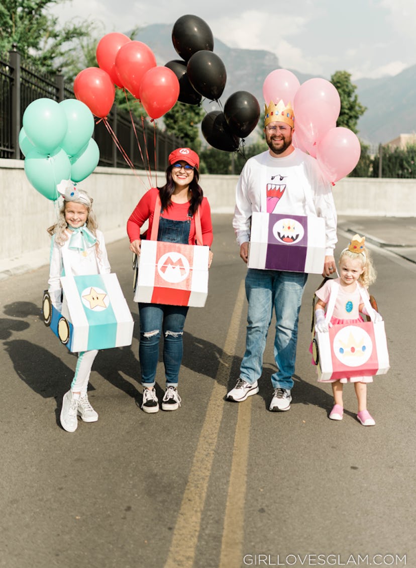 Mom, dad, and two girls dressed as characters from Mario Kart