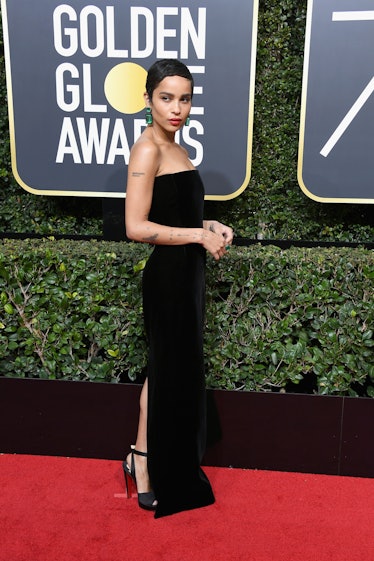 Zoe Kravitz in a black strapless dress with a slight slit on one leg at the Golden Globes' red carpe...