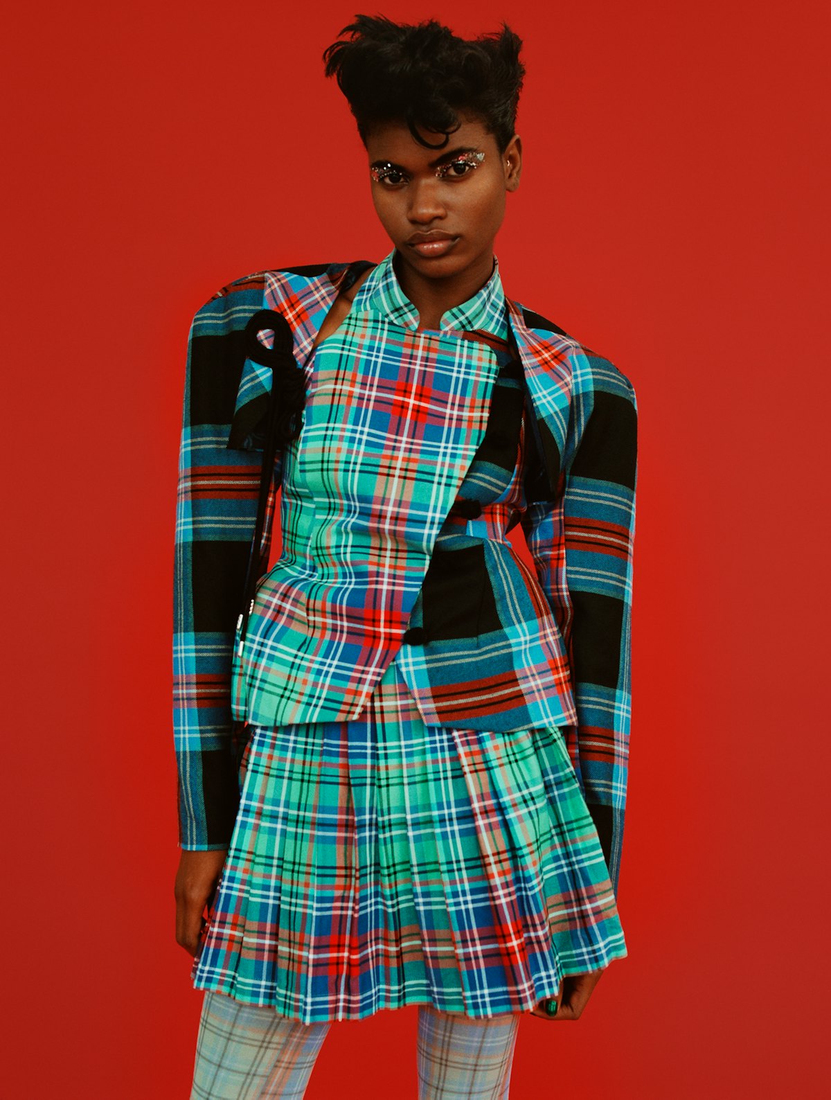 Briana Michelle  wears a Charles Jeffrey Loverboy jacket, skirt, and tights.