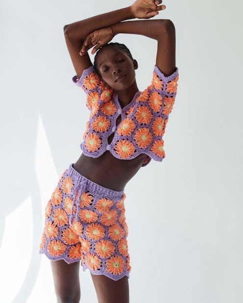 Model wears crochet top and shorts from Latina-owned clothing brand Tach Clothing.