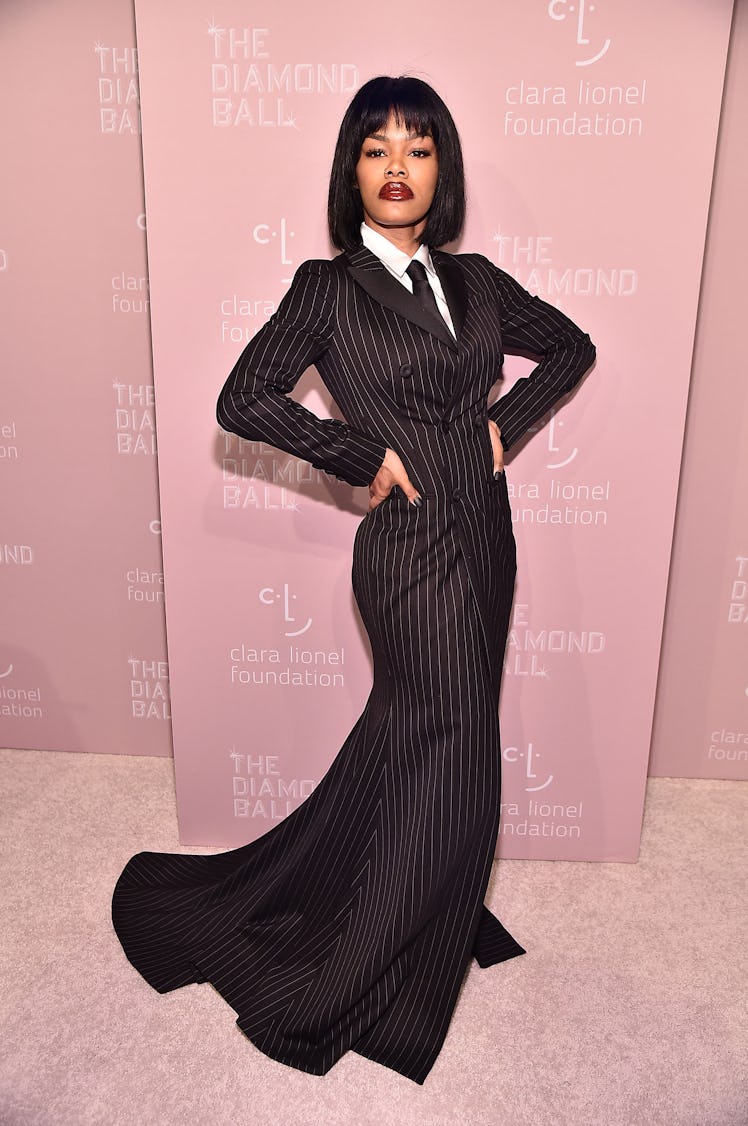Teyana Taylor at Rihanna's 4th Annual Diamond Ball in a black pinstripe suit-dress
