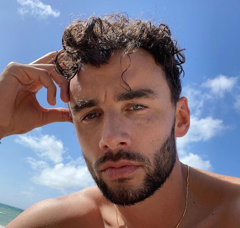 Brendan Morais taking a selfie on a beach