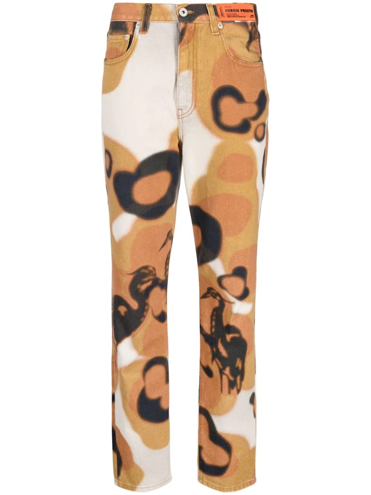 Camouflage printed slim jeans from Heron Preston, available to shop via Farfetch.