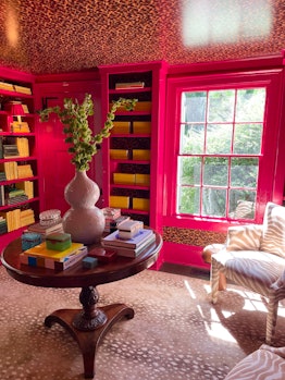 The home library of Brent Neale with bright pink walls
