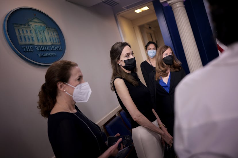 Actress and activist Angelina Jolie (2nd L) talks with reporters in the White House briefing room b...
