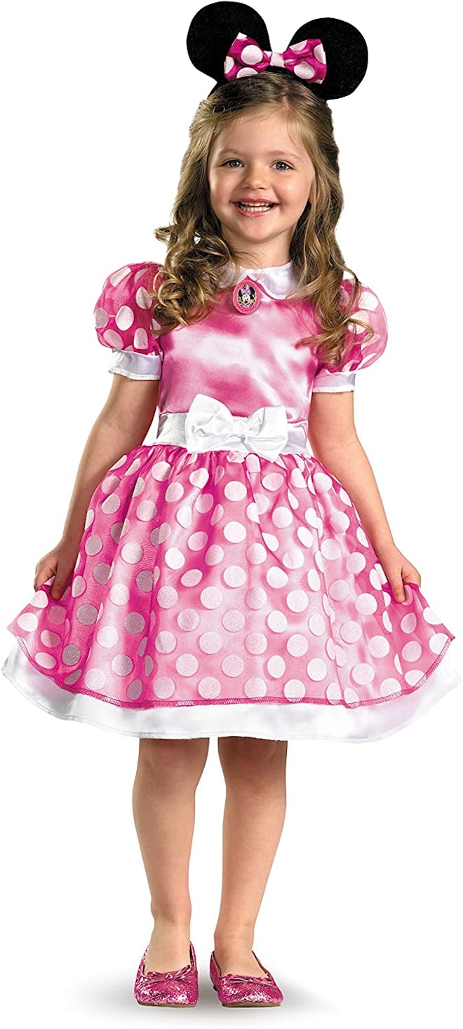 Toddler in pink Minnie Mouse dress and ears