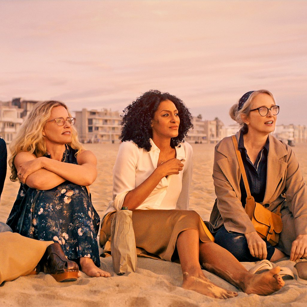 Four women sit on the beach and talk in the TV show 'On The Verge.'