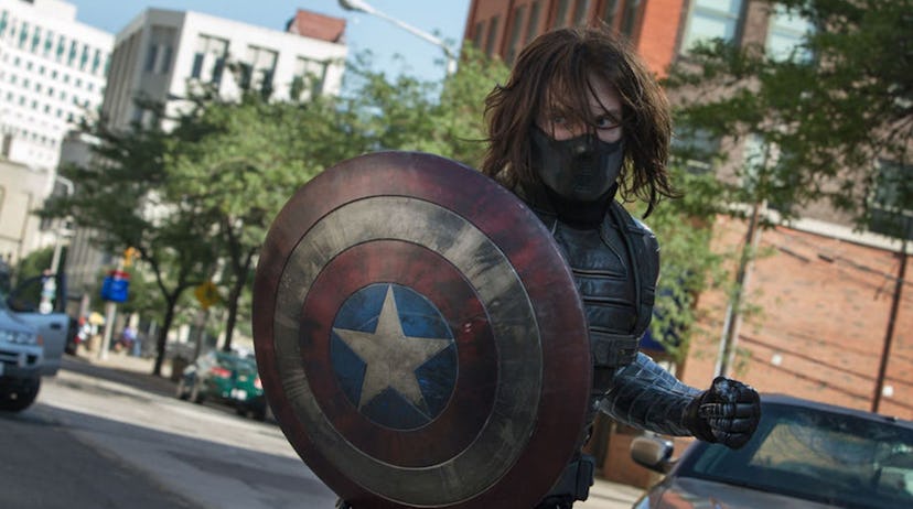 A still from 'Captain America: The Winter Soldier' with the masked, long-haired Winter Soldier holdi...
