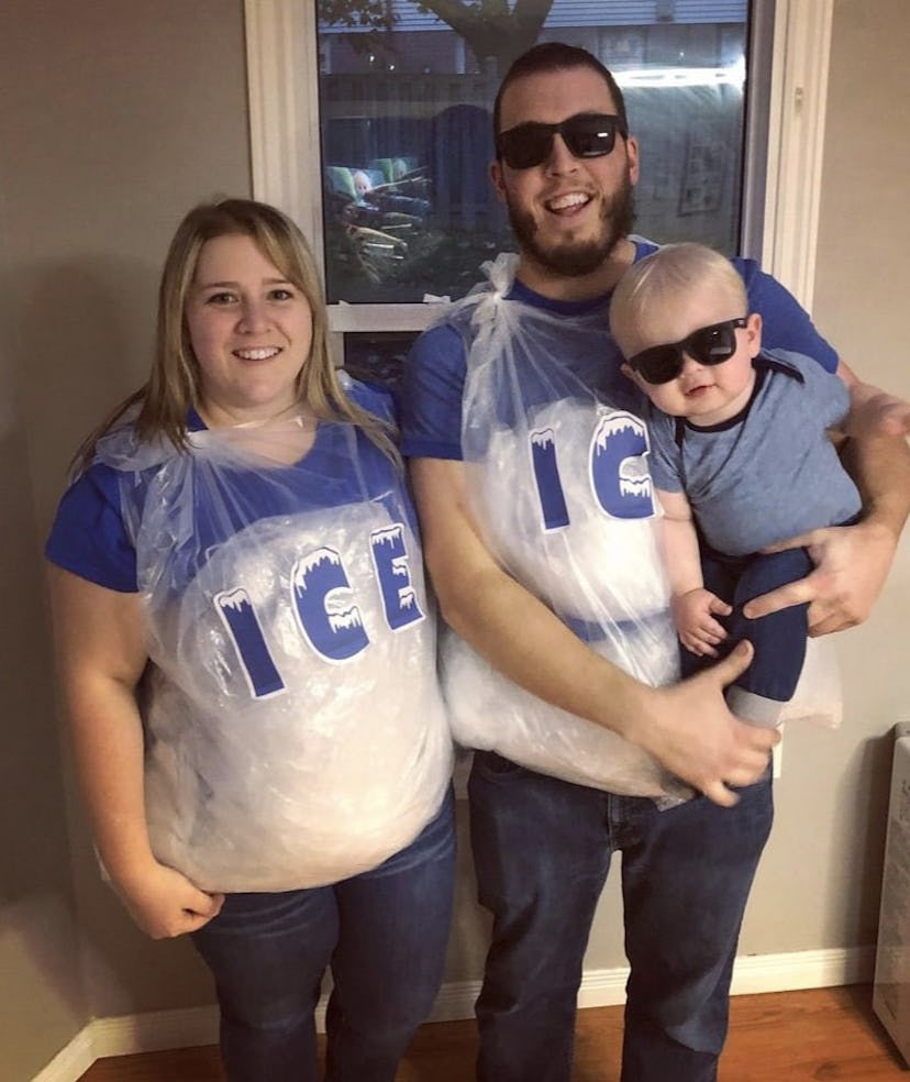 parents dresses as bags of ice, holding baby in sunglasses, they are the punny costume Ice Ice Baby
