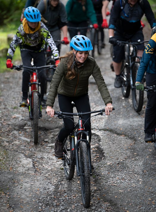 Catherine, Duchess of Cambridge rides a mountain bike during a visit to the Windermere Adventure Tra...