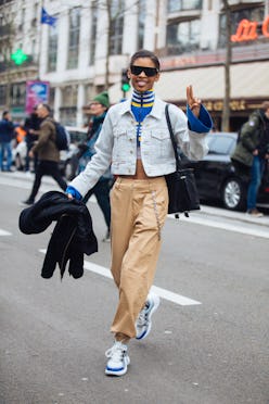 Theresa Hayes sticks out her tongue and gestures a peace sign while wearing black Victoria Beckham s...