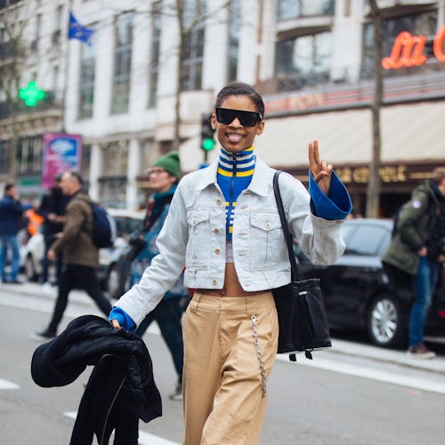 Theresa Hayes sticks out her tongue and gestures a peace sign while wearing black Victoria Beckham s...