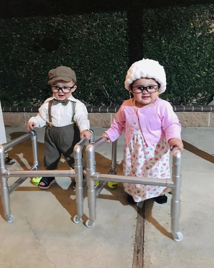 two babies dressed as elderly people with walkers for Halloween