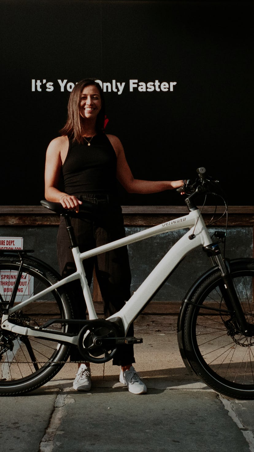 A woman standing with the Turbo Vado.