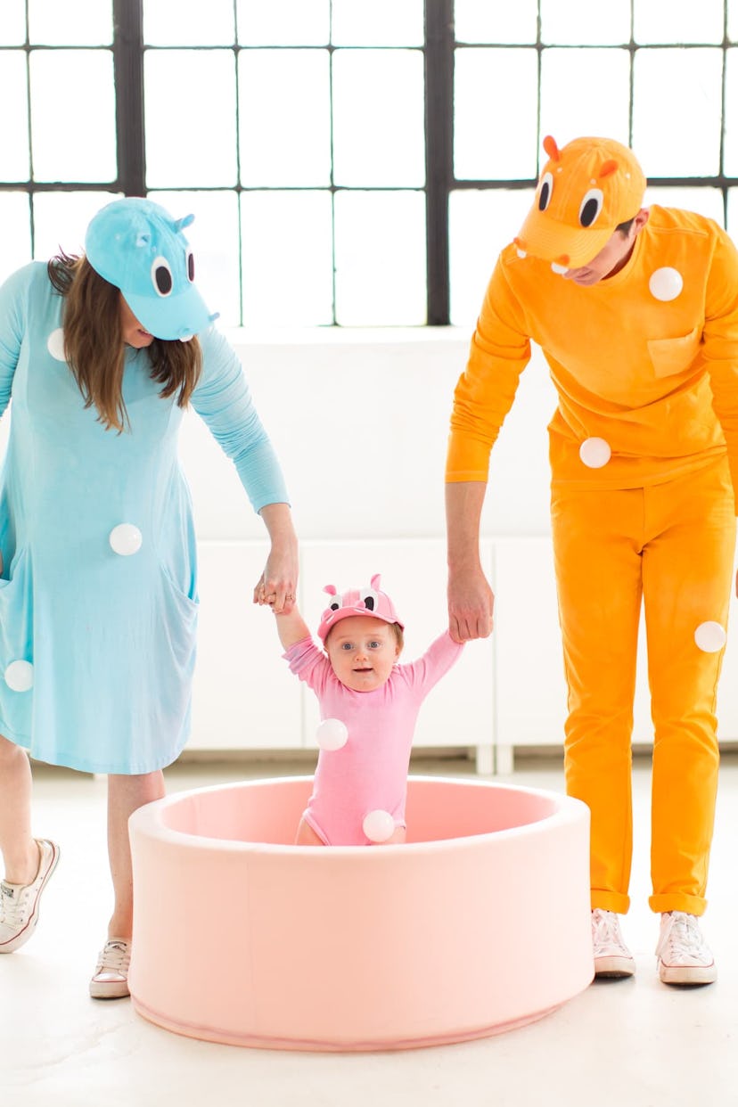 Mom, Dad, and baby dressed in Hungry, Hungry Hippos costumes 
