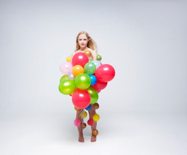Woman dressed as a bundle of colorful balloons