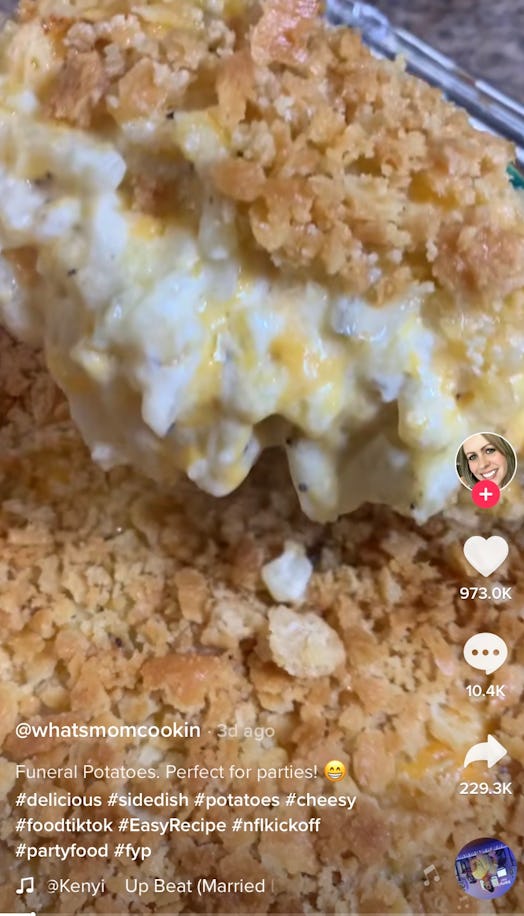 A woman scoops up some of TikTok's viral funeral potatoes recipe, while showing how to make this has...