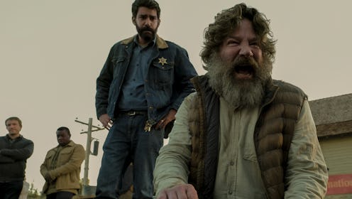 A sheriff standing over a screaming man in a still from MIDNIGHT MASS.
