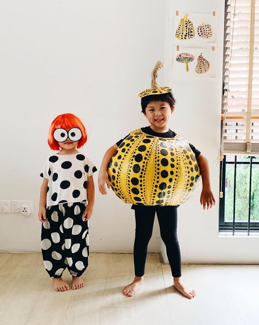 Kids dressed in costume as artist Yanoi Kusama, and her older brother dressed as Kusama decorated pu...