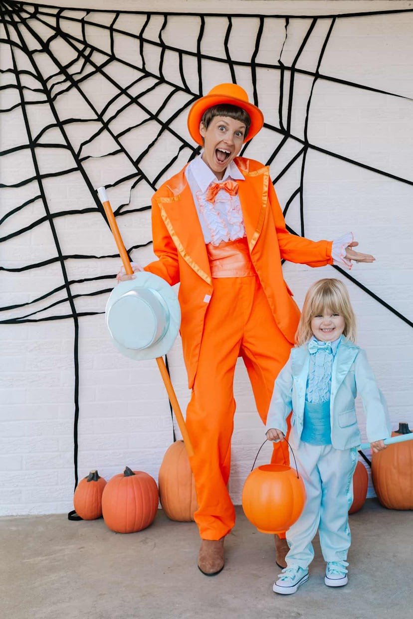 Mom and daughter in Halloween costumes from Dumb and Dumber, orange and blue suits