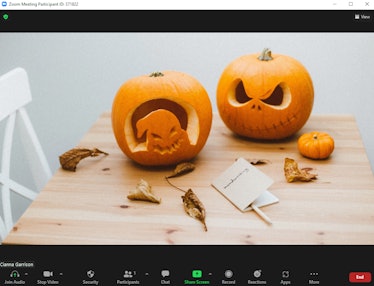 These Halloween Zoom backgrounds include a pumpkin carving scene.