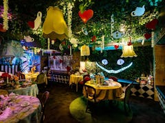 The 'Alice in Wonderland' bar in NYC has immersive experiences and a Cheshire Cat wall.