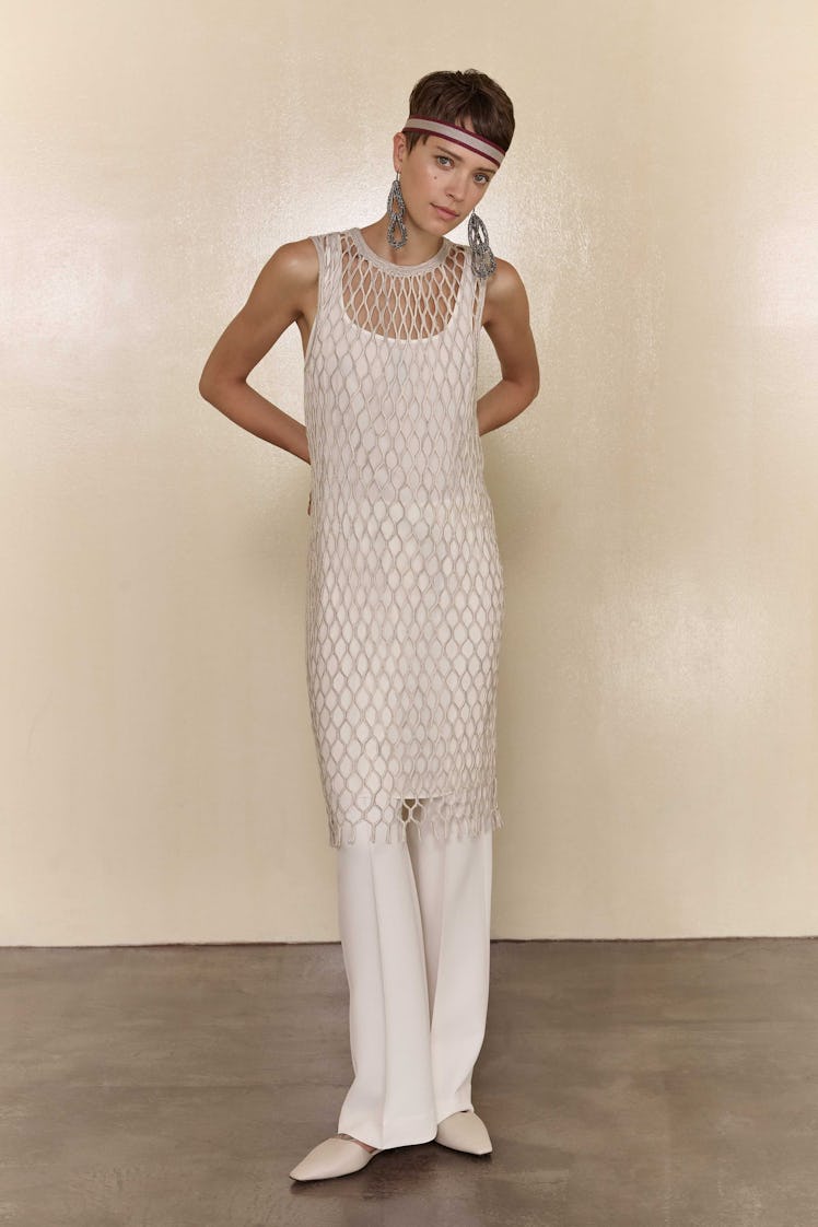 A model in a beige fish-net top with a matching tank top and pants from Brunello Cucinelli