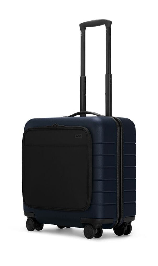 Image of Away brand's small carry-on wheeled suitcase.