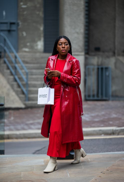 A guest is seen wearing red coat, dress outside RIXO during London Fashion Week September 2021 on Se...