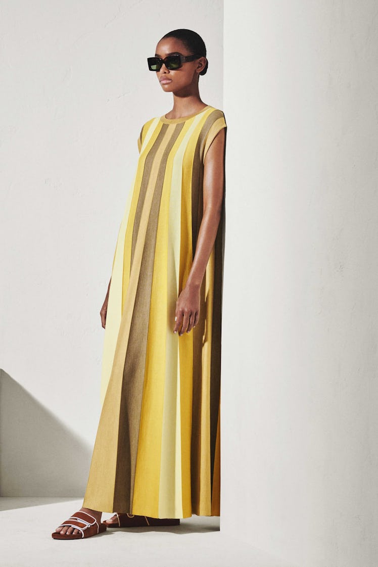 A model in a Loro Piana yellow striped floor-length dress 