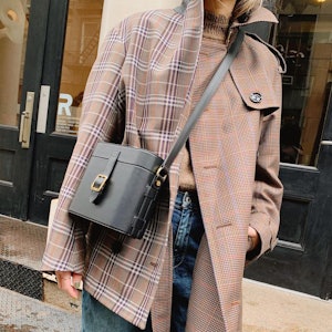 Caroline Maguire wearing a mix-matched plaid coat.