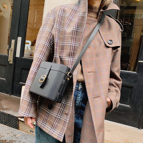 Caroline Maguire wearing a mix-matched plaid coat.