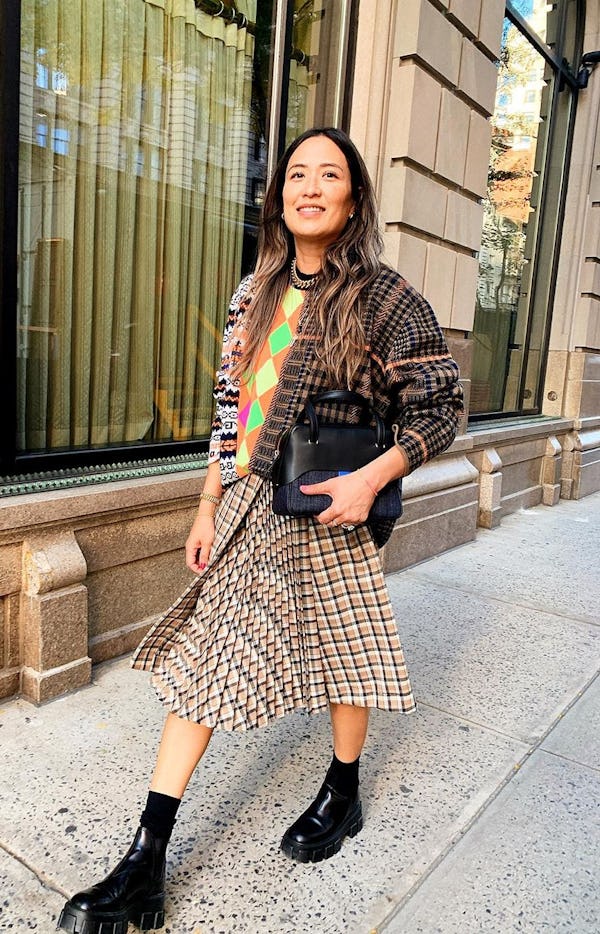 Caroline Maguire wearing a plaid jacket and checked skirt.