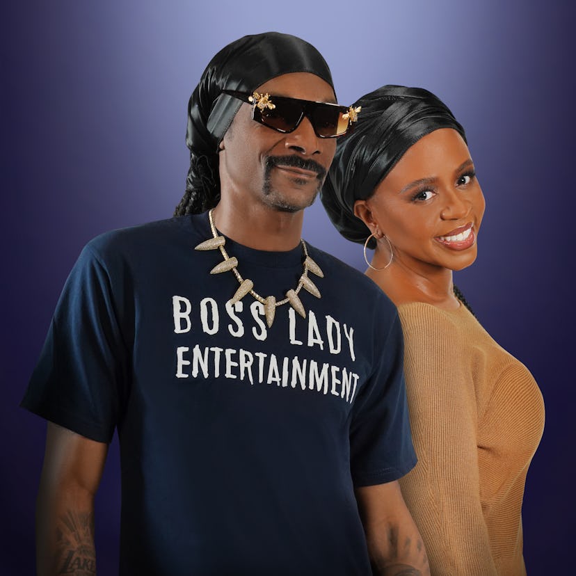 Snoop Dogg with his wife, Shante Broadus, posing in The Boss Lady Entertainment t-shirt and the Broa...