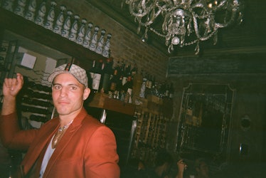 Jake Brodsky dancing in an orange blazer at a restaurant