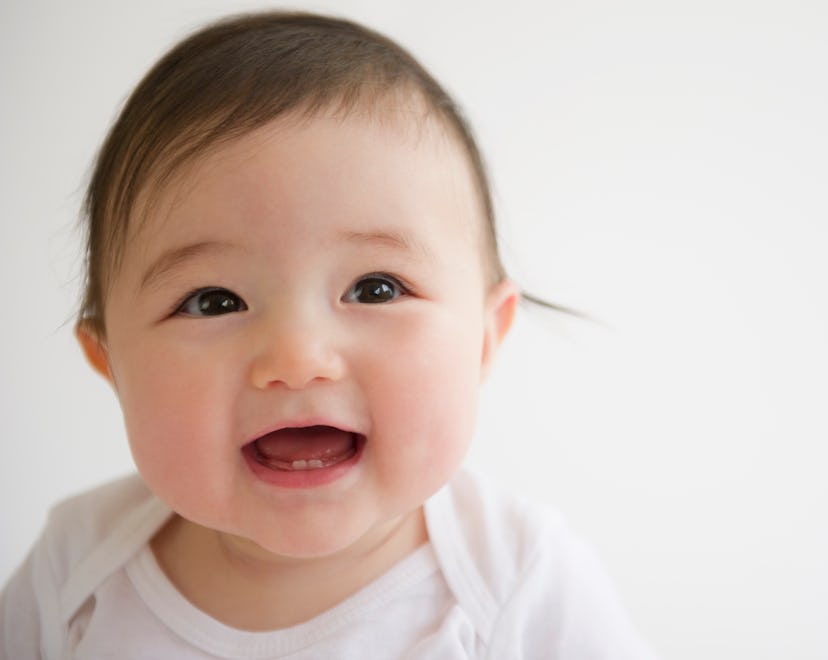 closeup of smiling baby, baby name trends of 2022 