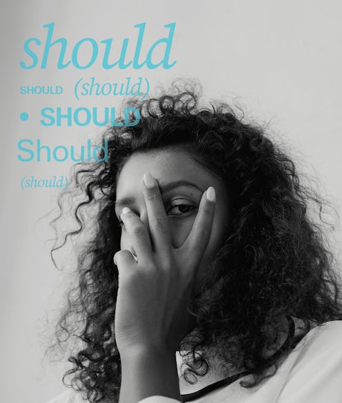 A woman holding her left hand over her face and a lot of blue "should" text signs