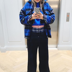 Caroline Maguire wearing a bright blue plaid outfit.