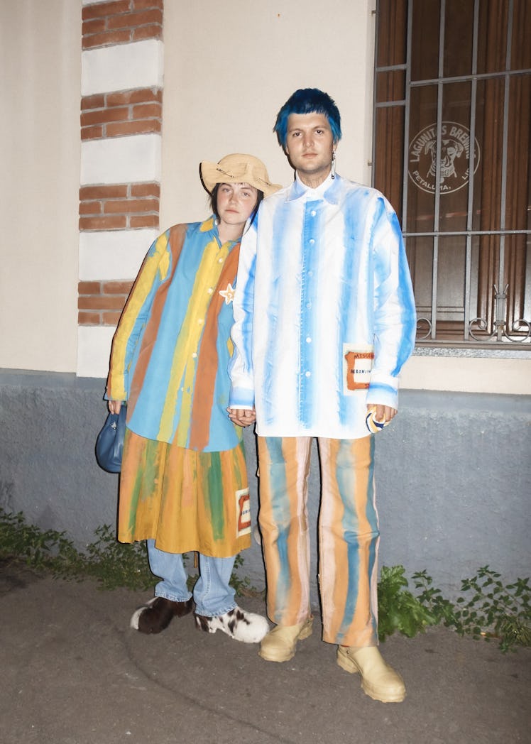 Two people in striped upcycled shirt in white-blue and blue-yellow and similar matching pants