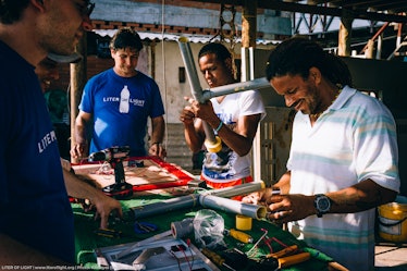 Illac Diaz building solar lights in Colombia.