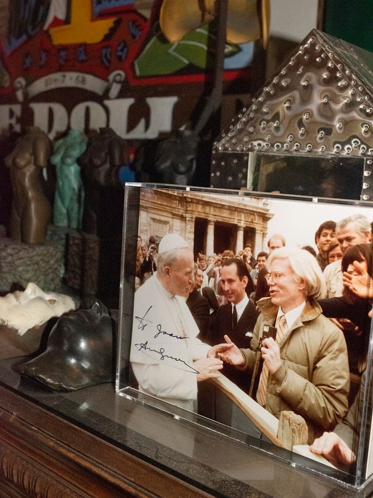 A photo of Andy Warhol and Pope John Paul II, autographed and gifted to Quinn by  the artist.