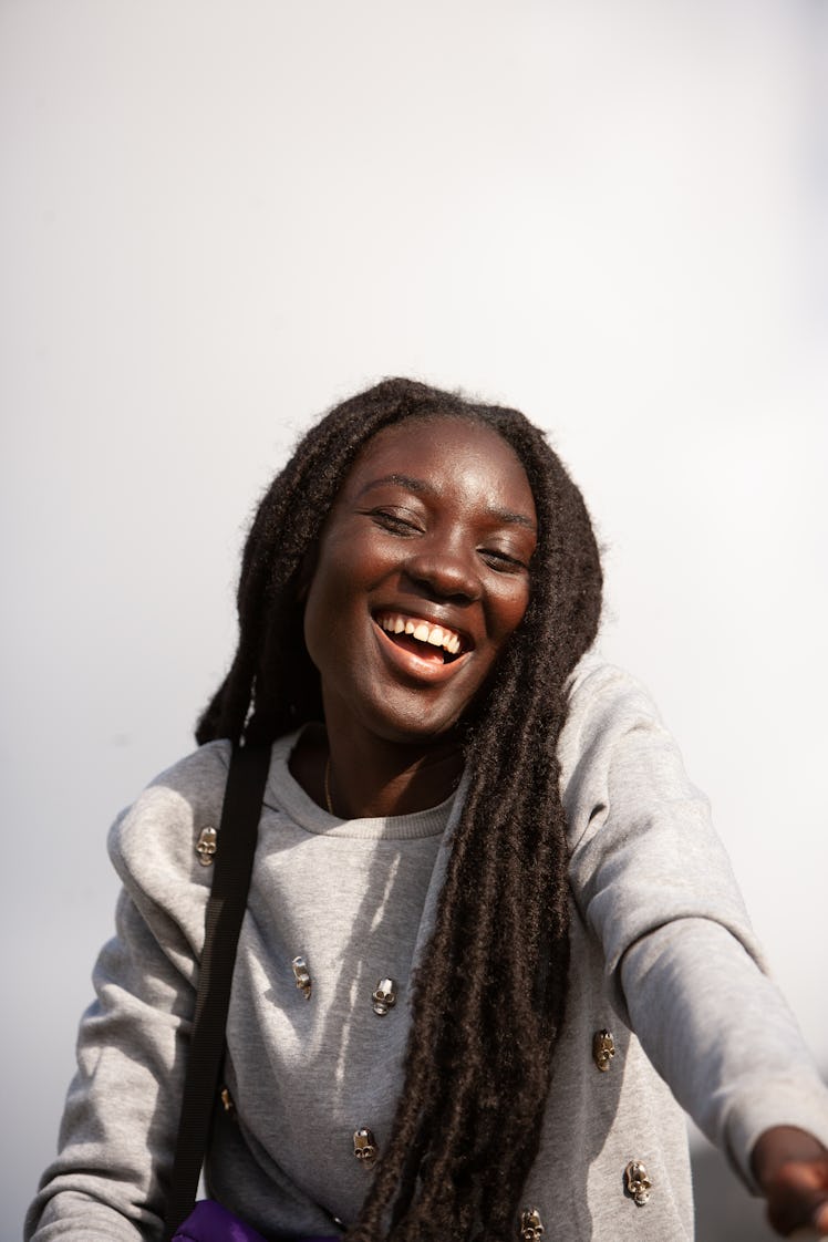 Happy young woman taking a selfie the week of October 4, 2021, the best for her zodiac sign.