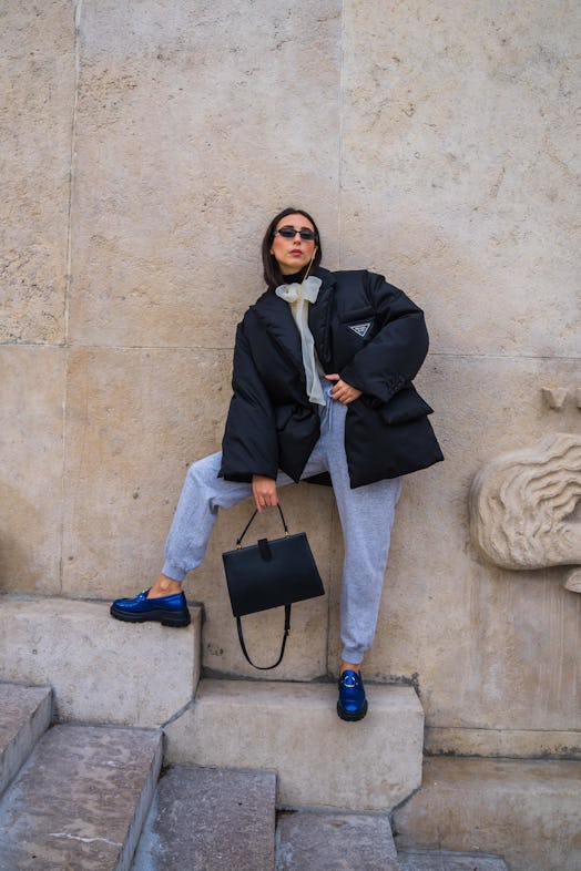 Gabriella Berdugo wears sunglasses from Ralph Lauren, a black puffed winter oversized jacket from Pr...