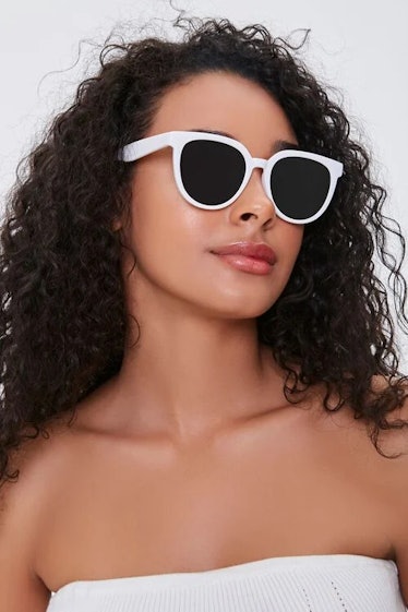Rachel on 'The White Lotus' wears white-framed sunglasses.