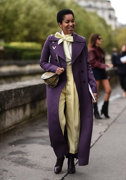 Tamu McPherson is seen wearing a Valeinto purple coat and yellow top and pants outside the Valentino...