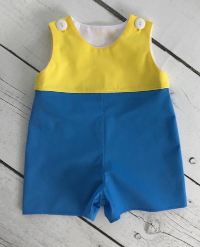 Flat lay of Christopher Robin costume for babies
