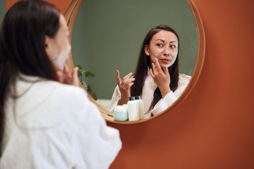 woman applying skin care products